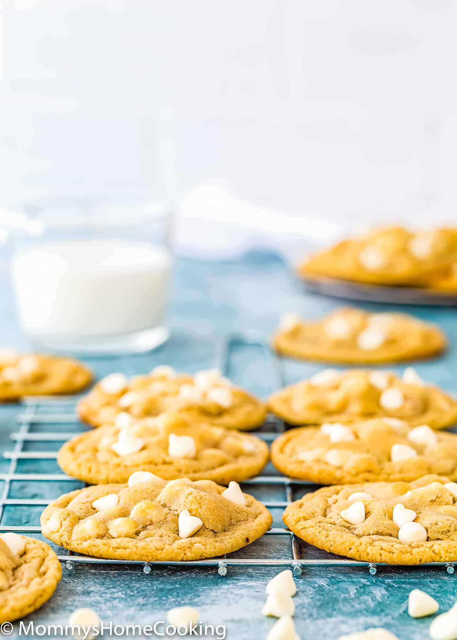 Eggless White Chocolate Cookie over a cooling rack with white chip on the sides