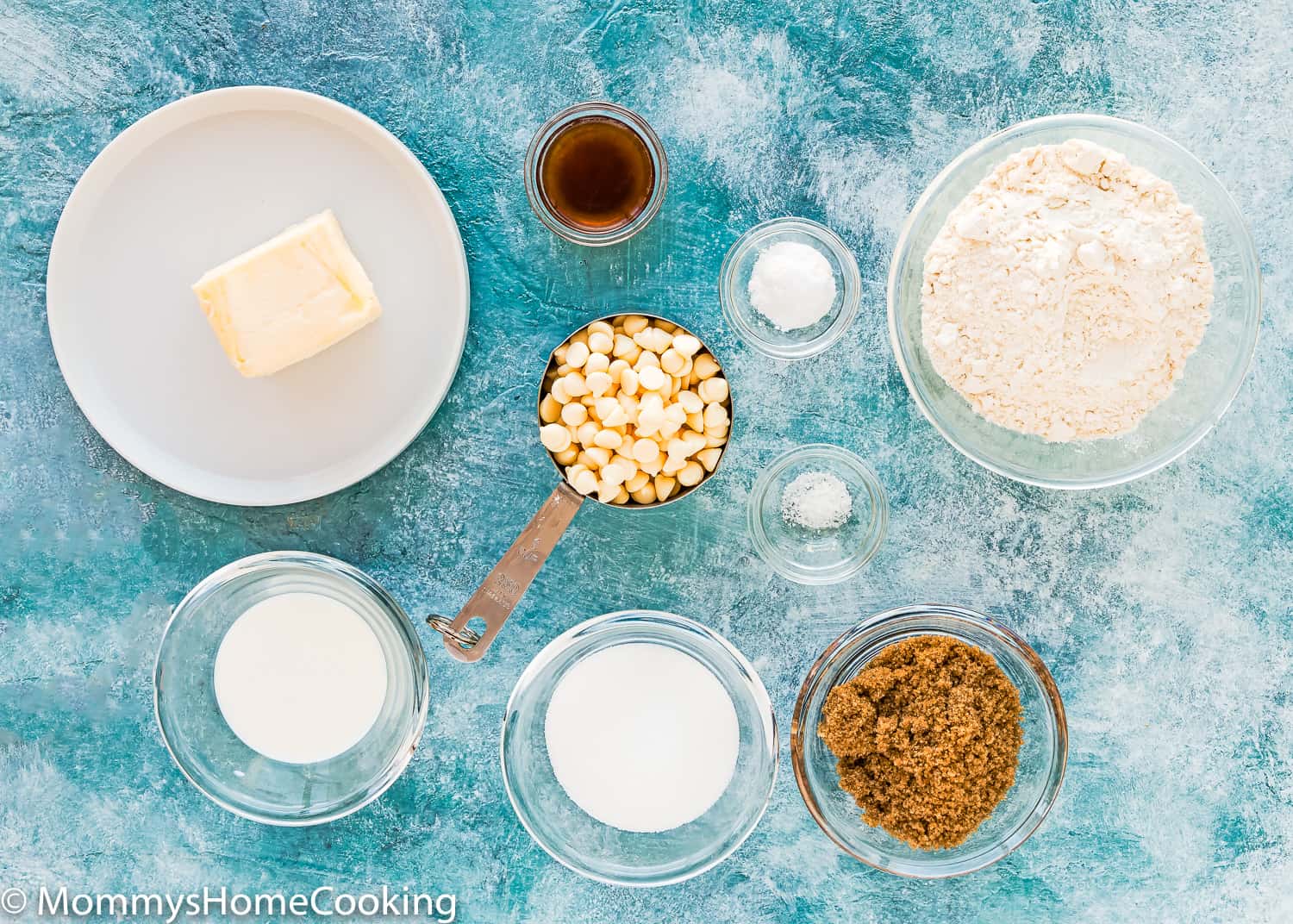 Eggless White Chocolate Cookie ingredients over a blue surface