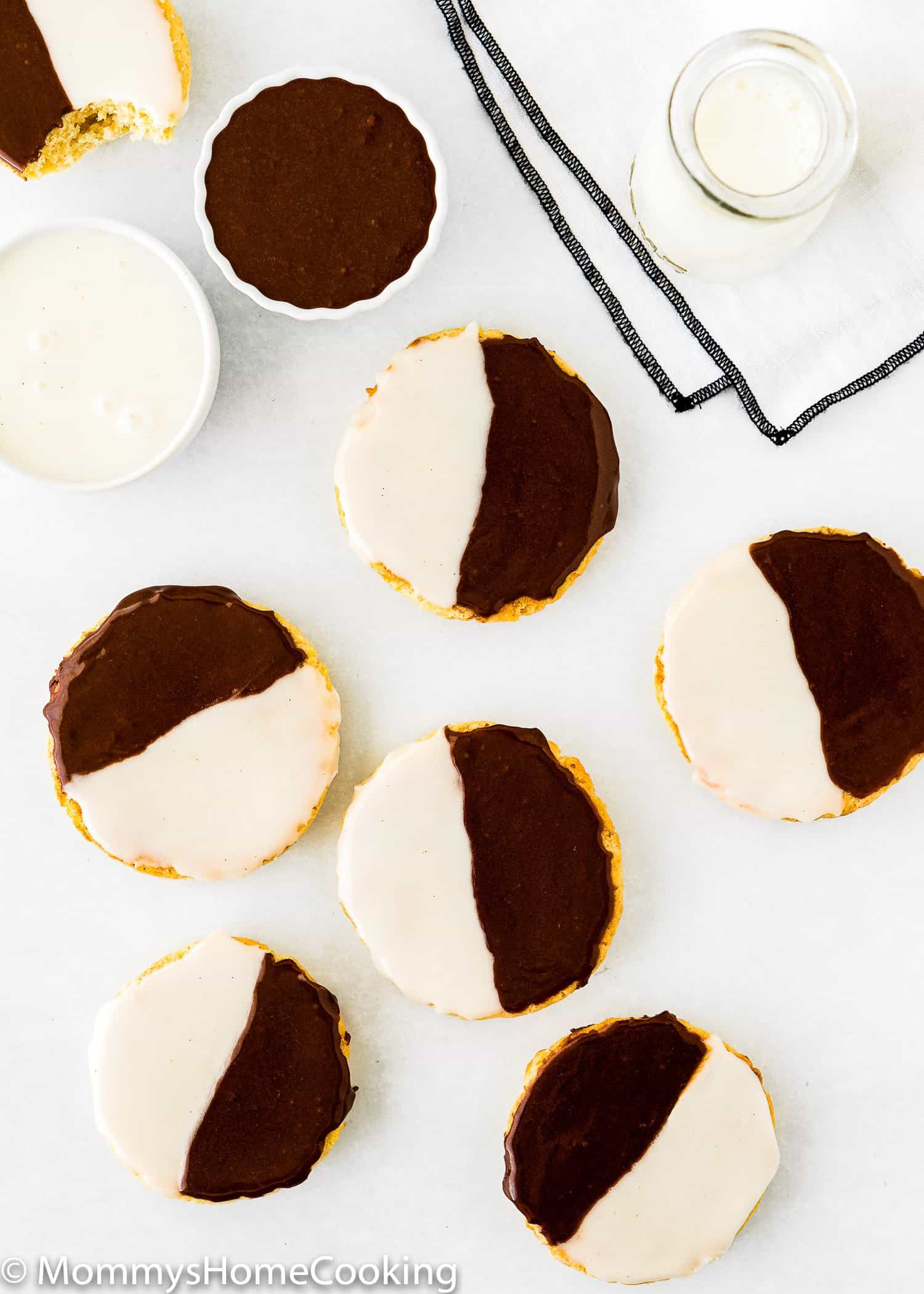 overhead view of Black and White Cookies over a white surface.