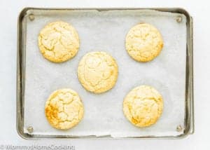 5 eggless Black and White Cookies on a baking sheet