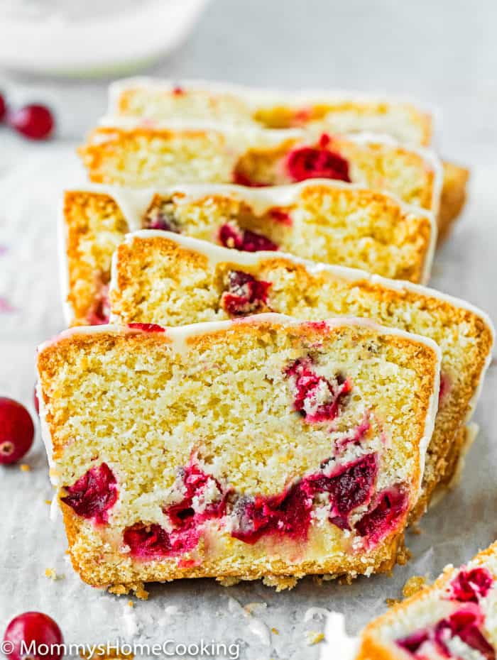 sliced Eggless Cranberry Orange Bread with orange glaze