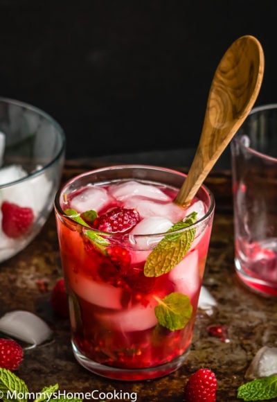 a Raspberry Vodka Mojito in a glass with a spoon on it