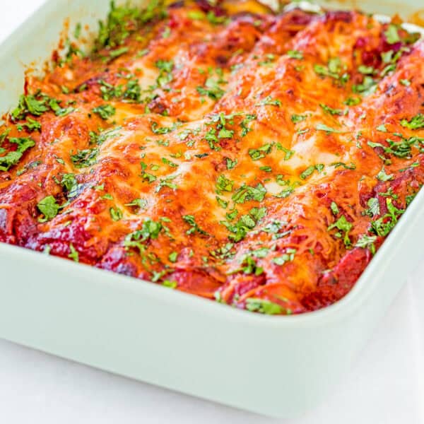 Easy Eggless Cheese Manicotti in a baking dish with chopped basil on top.