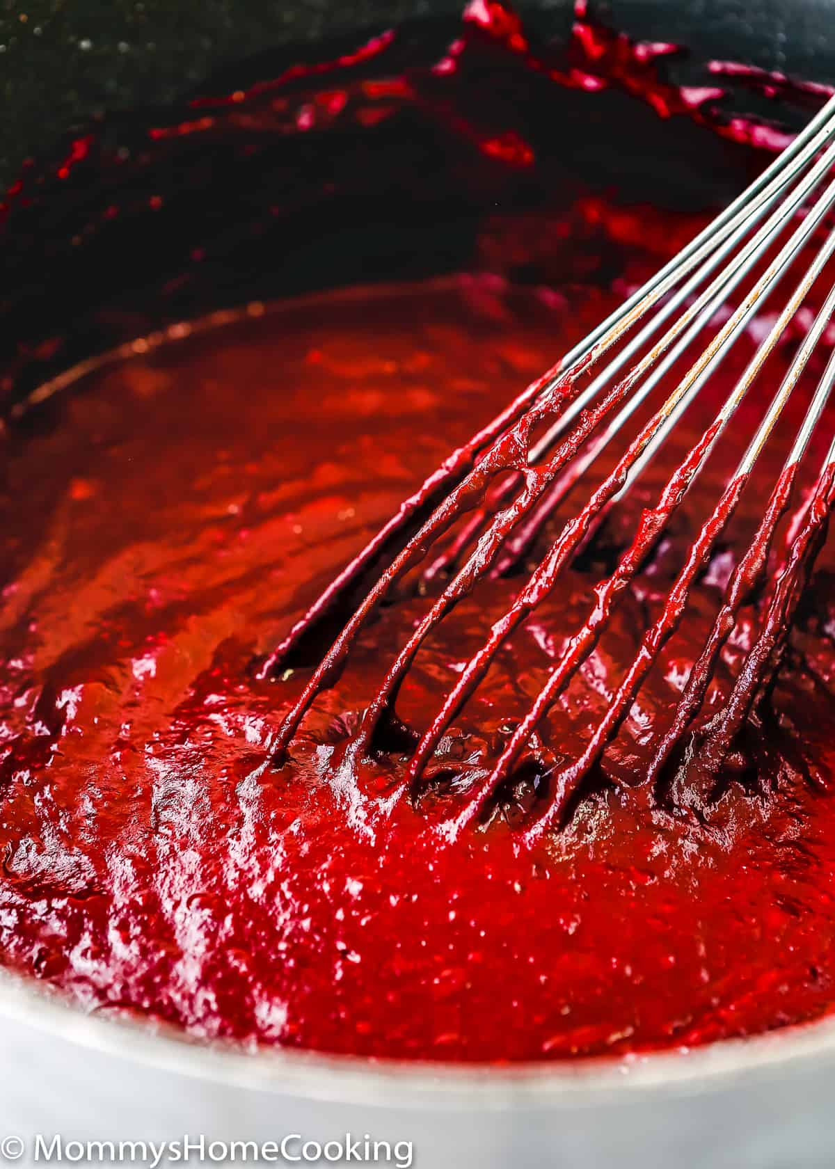Eggless Red Velvet Brownies batter in a bowl with a whisk