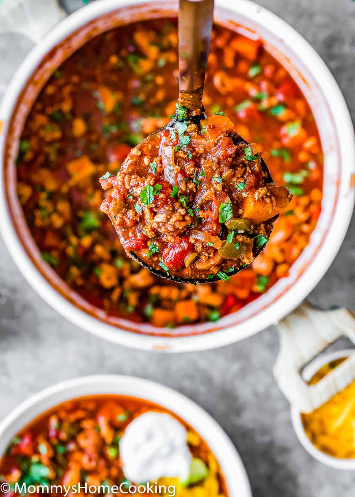 a serving spoon with turkey chili.