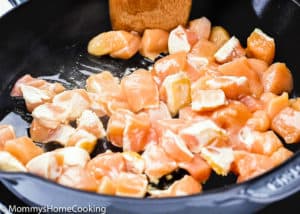 raw chicken in a skillet.