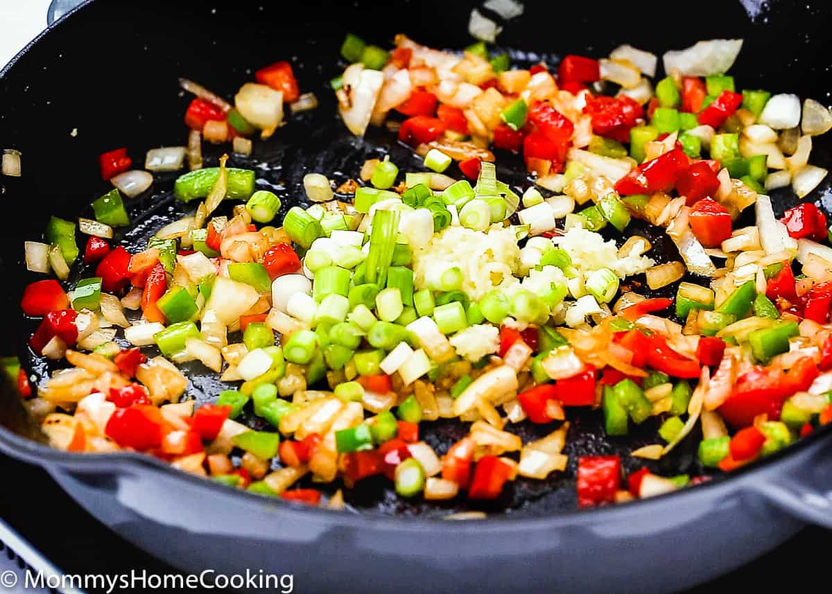 chopped onion, pepper, garlic and green onion in a skillet.