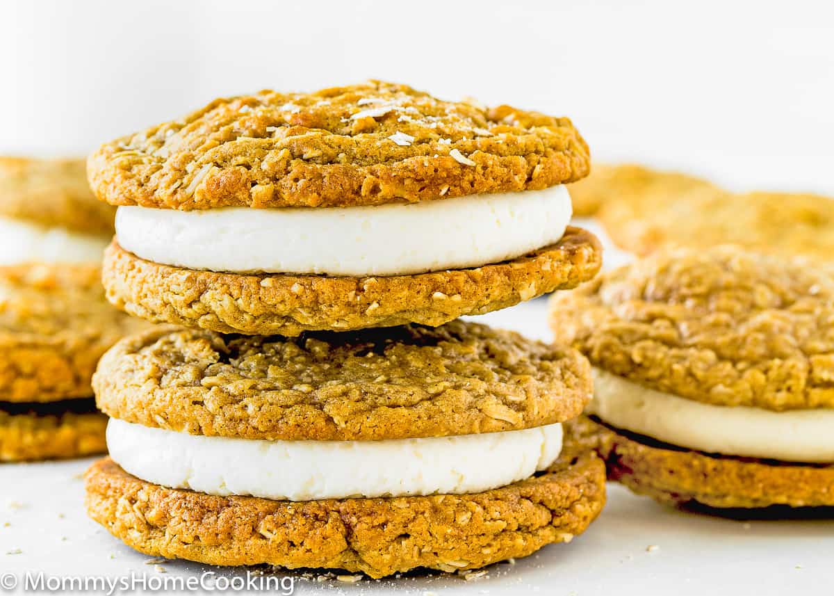 two Eggless Oatmeal Cream Pies with quick oats sprinkled on top.