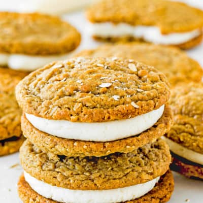 two Eggless Oatmeal Cream Pies with more cream pies in the background.