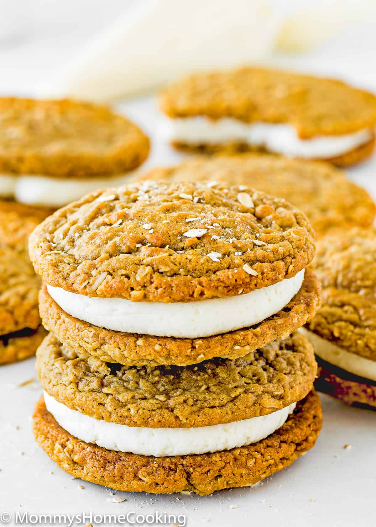 two Eggless Oatmeal Cream Pies with more cream pies in the background.