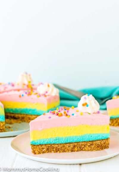no-bake easter cheesecake slice on a plate with whipped cream and sprinkles.