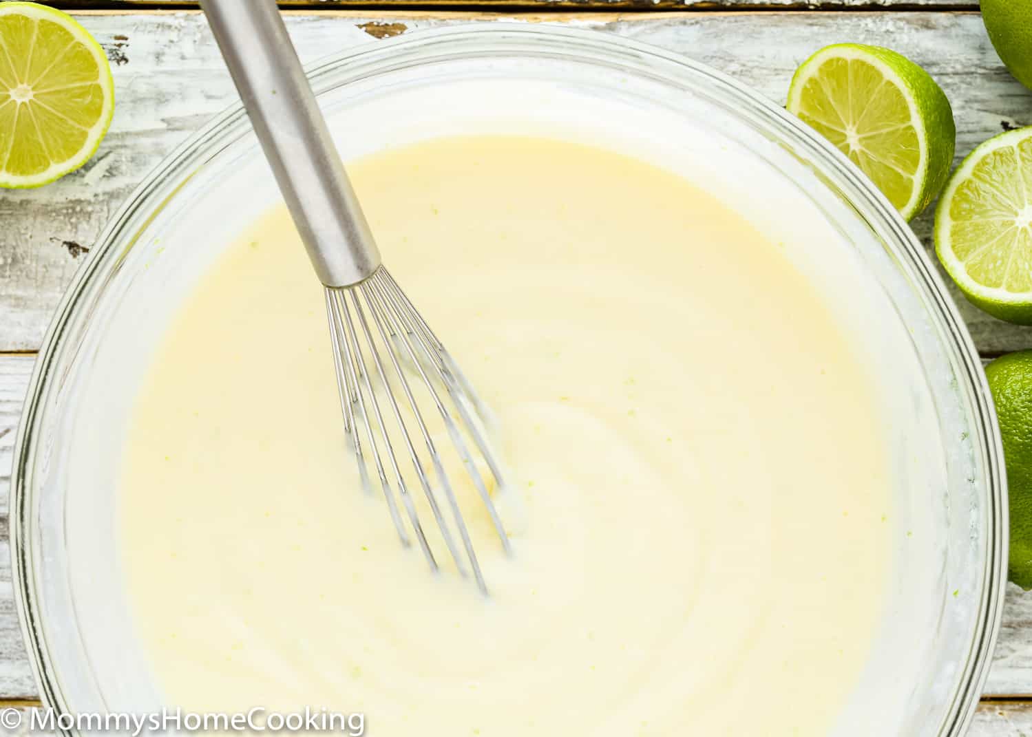 egg-free key lime filling in a bowl with a whisk.