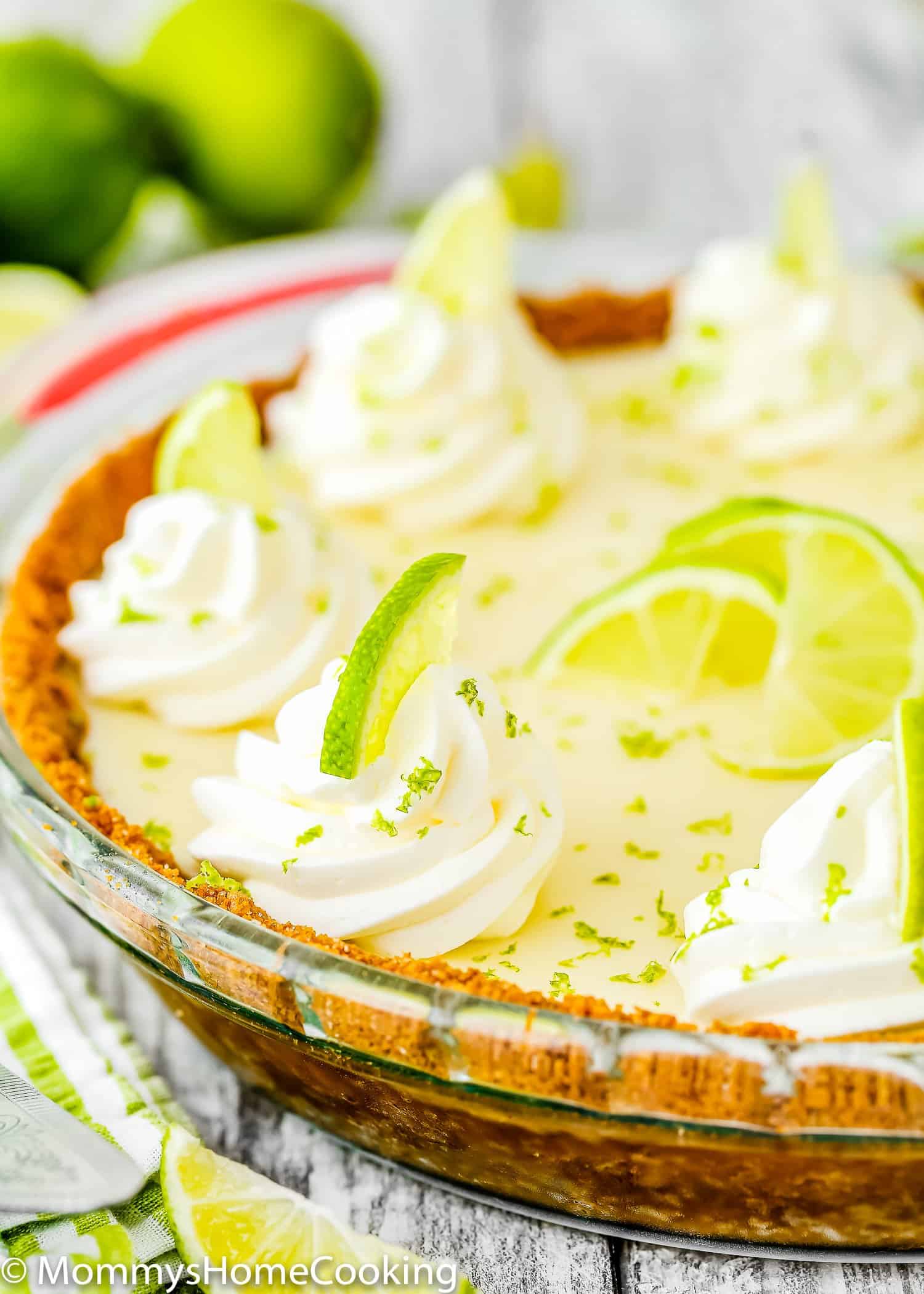 eggless key lime pie with whipped cream and fresh lime zest on top.