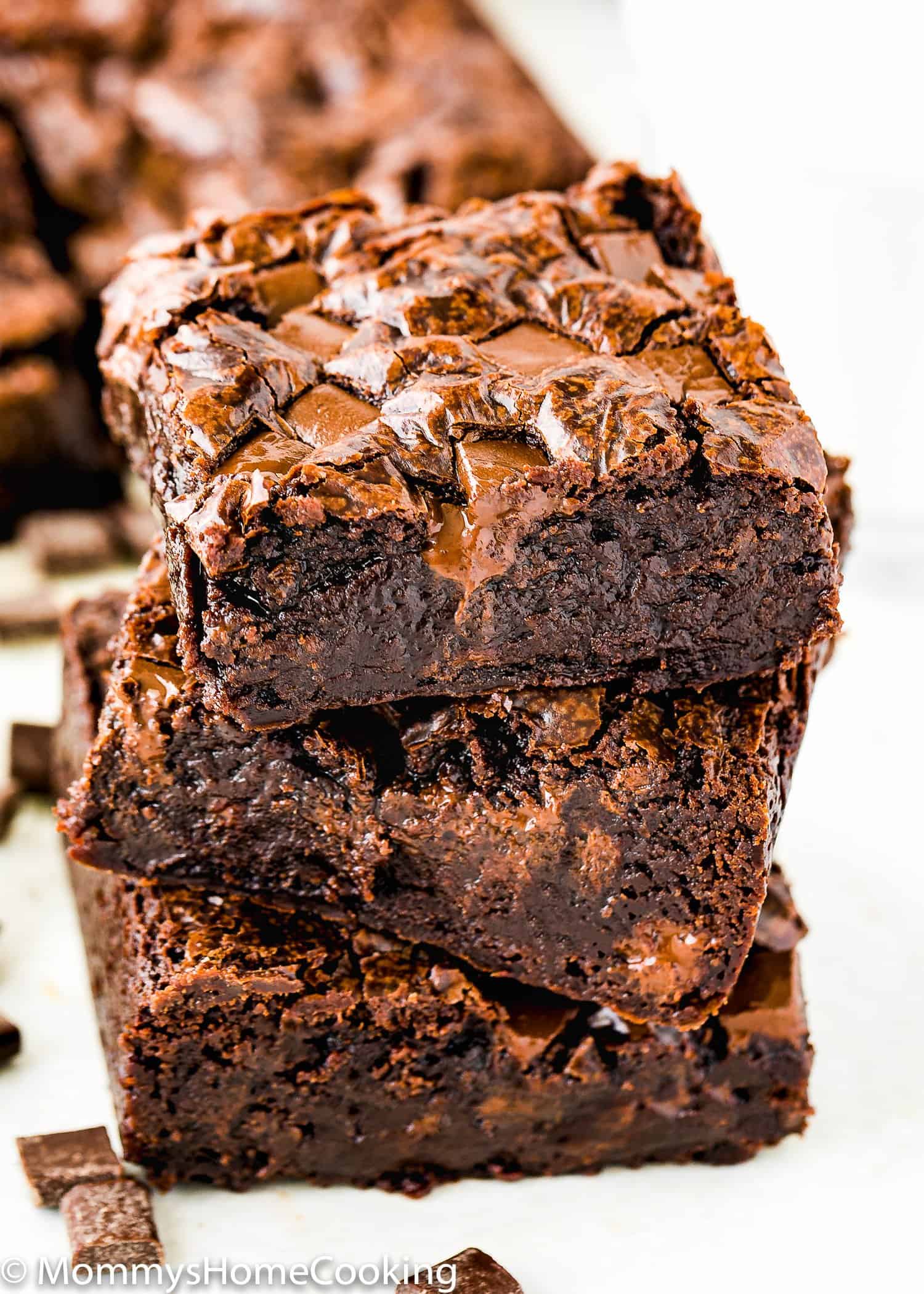 stack of three eggless Fudgy brownies with crackly top.