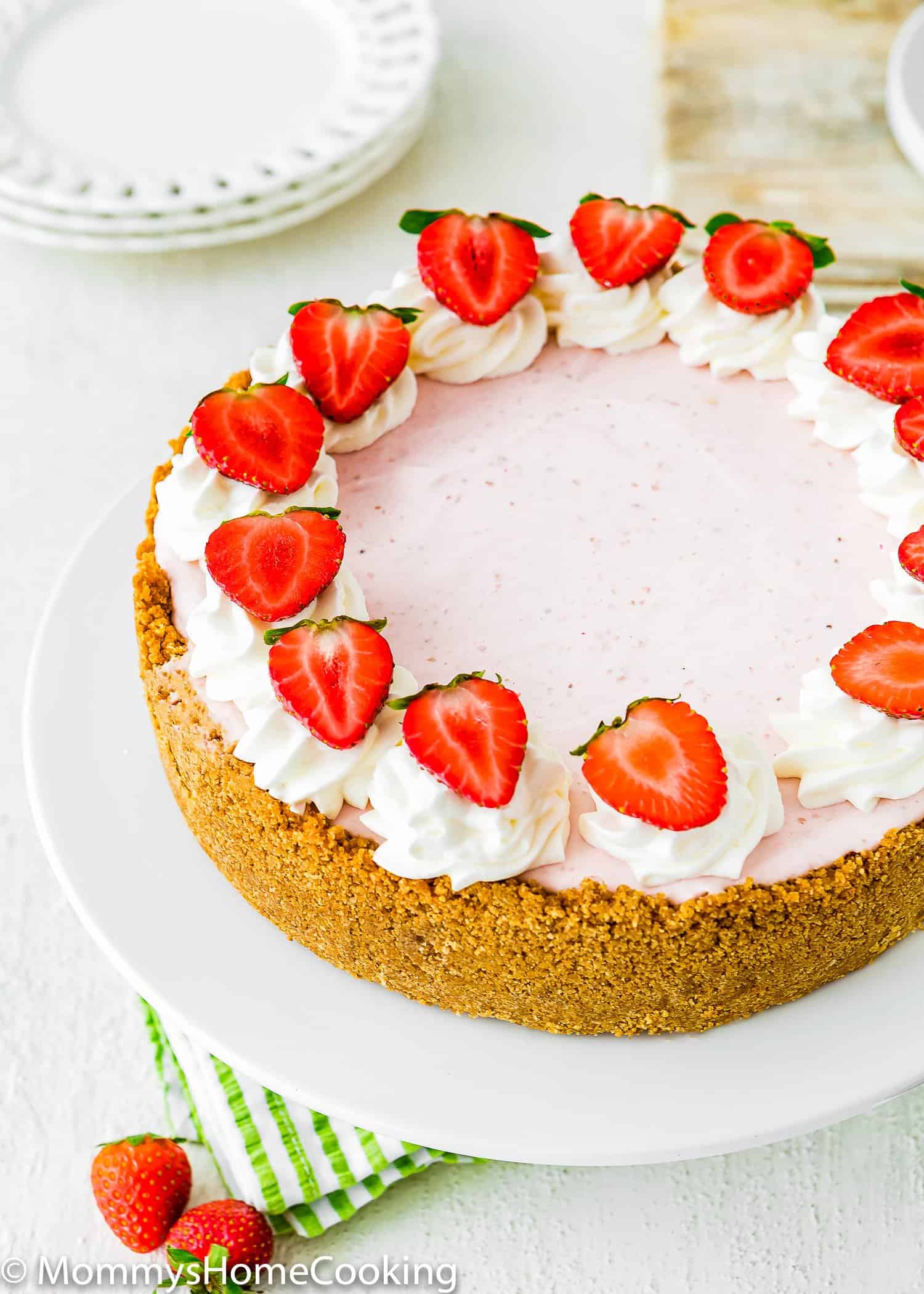 No-Bake Strawberry Cheesecake with fresh strawberries and whipped cream on top.