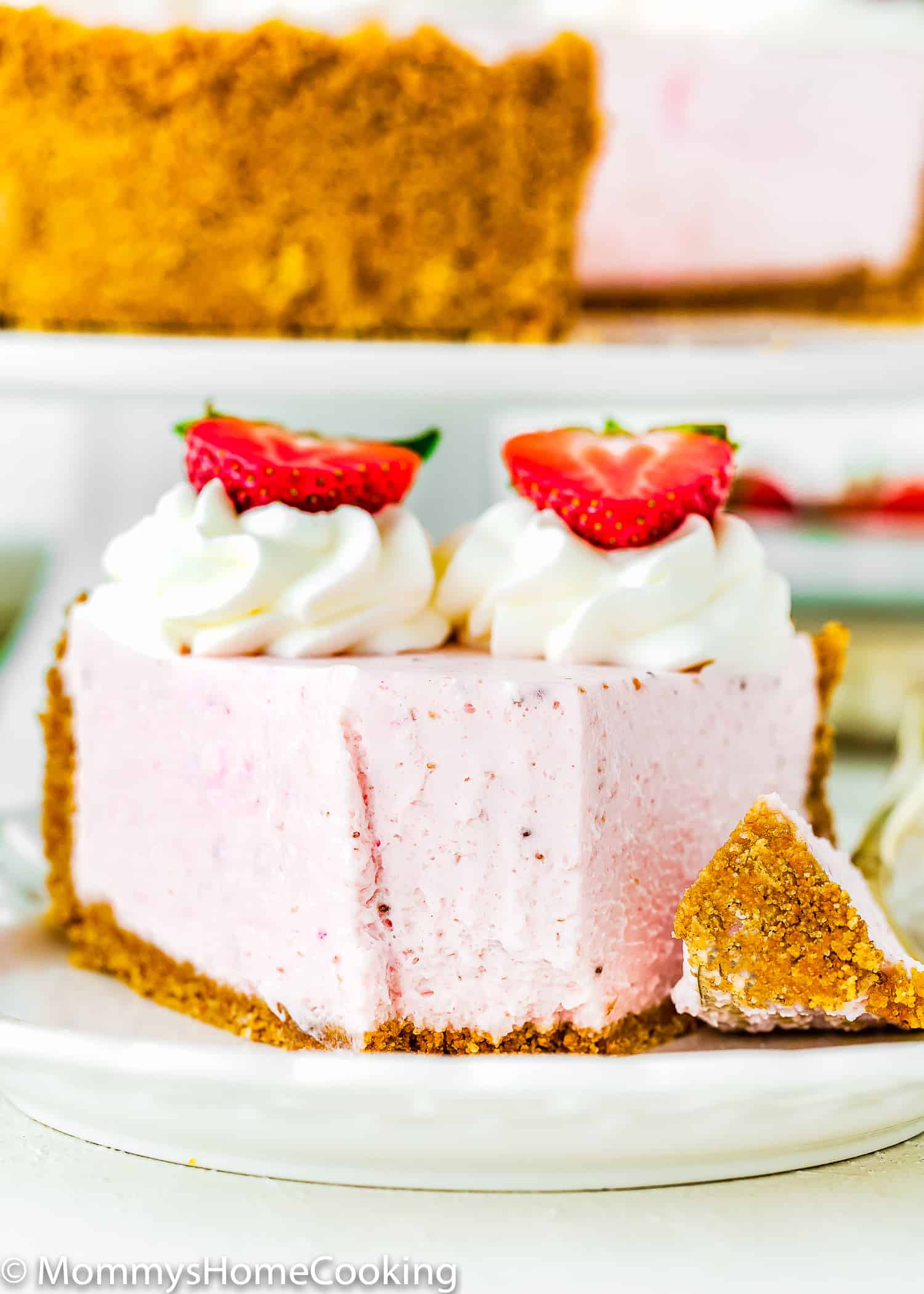 a slice of No-Bake Strawberry Cheesecake showing its creamy texture.