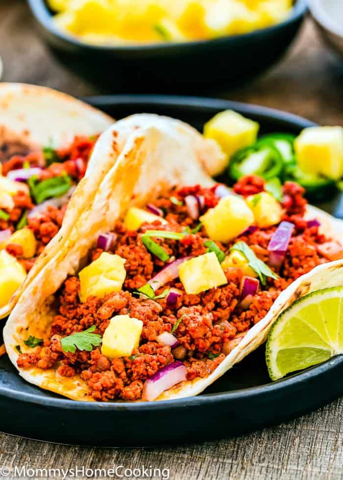 one taco al pastor on a black plate.