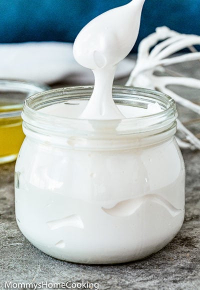 a spoon showing how stretchy and perfect Homemade Eggless Marshmallow Fluff is.