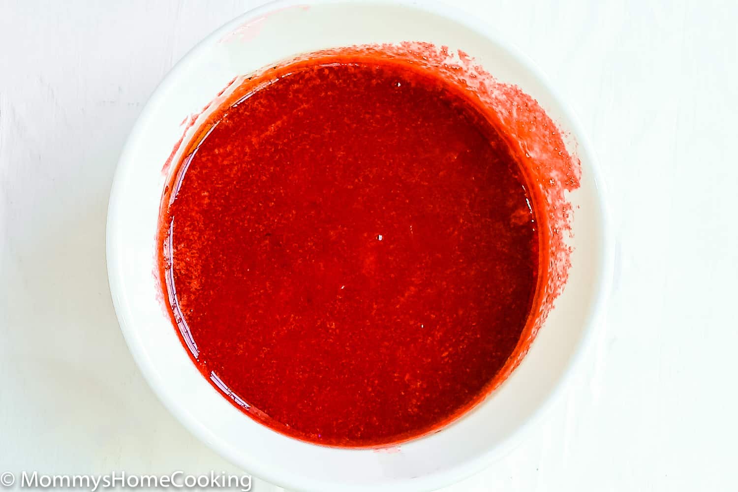 strawberry sauce in a white bowl.