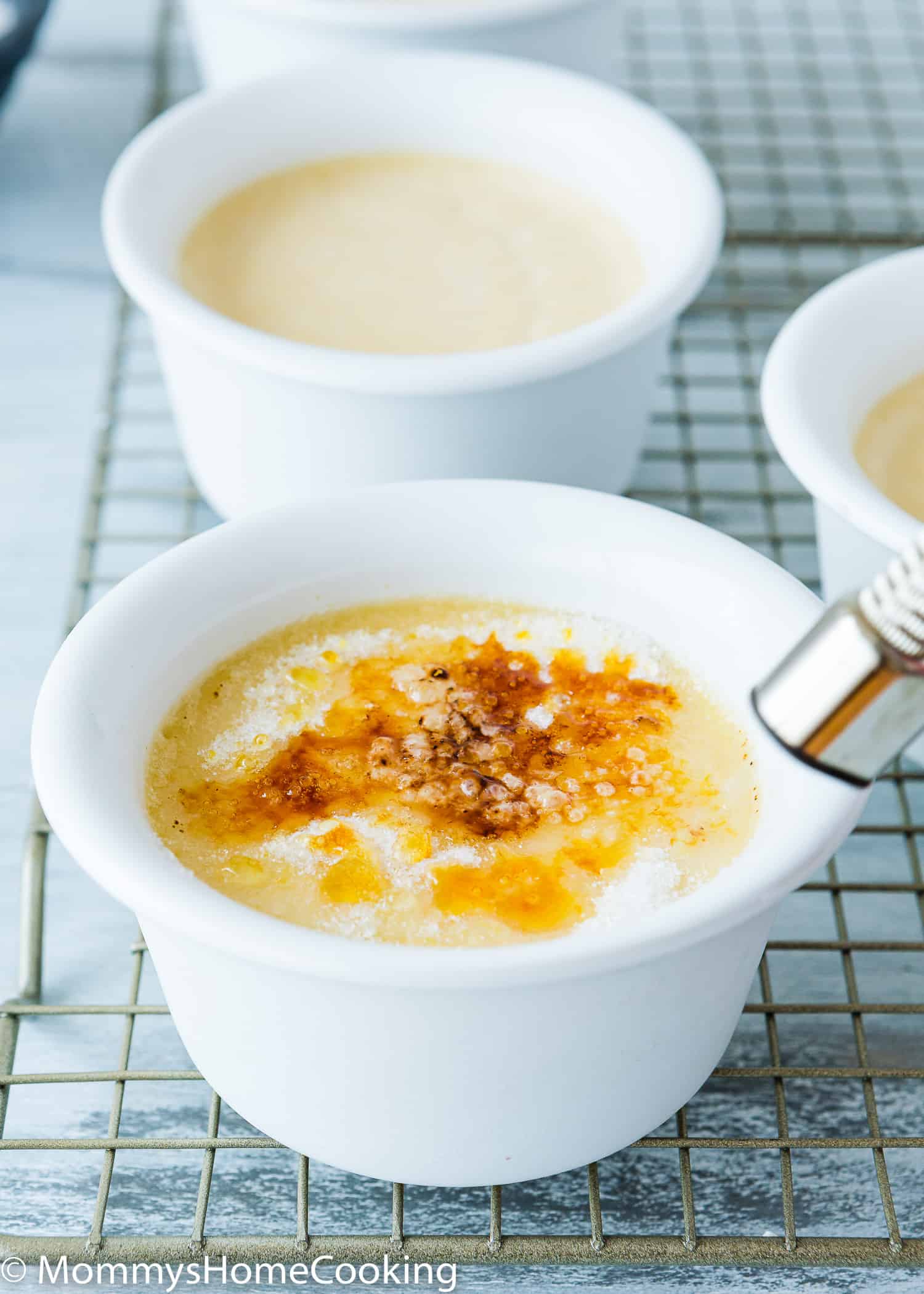 a torch caramelizing a eggless creme brulee.