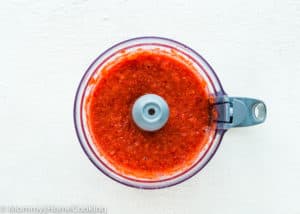 Crushed strawberries in a food processor.
