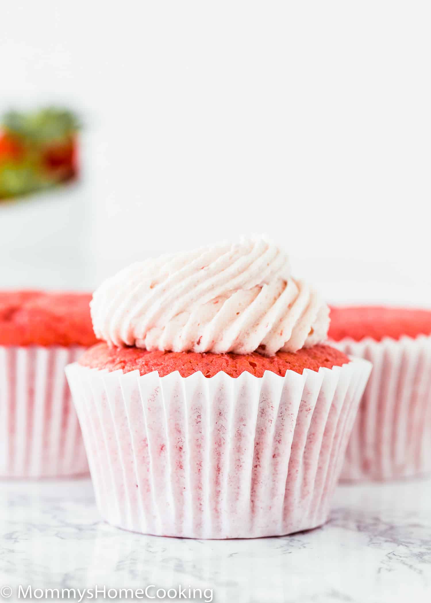 eggless strawberry cupcake with strawberry frosting on top.