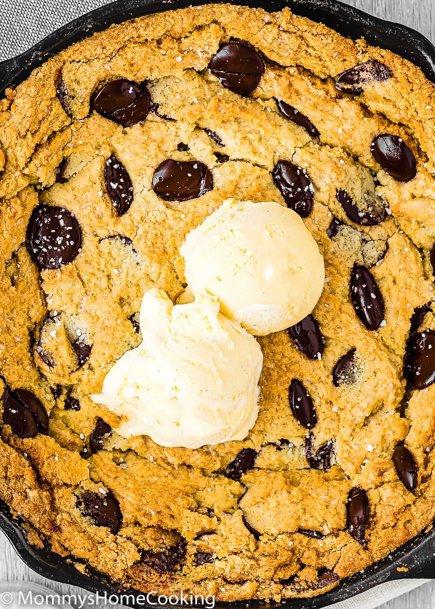 a Eggless Chocolate Chip Skillet Cookie with ice cream on top.