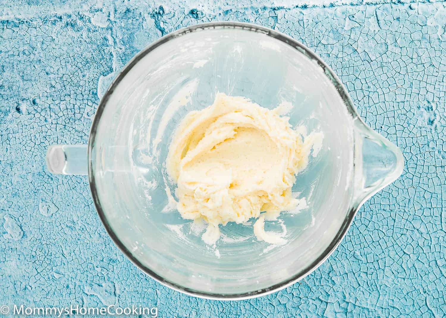butter, sugar, and yogurt mix together in a glass bowl.