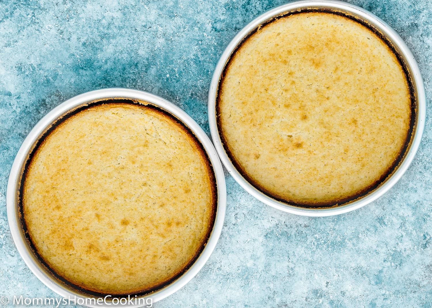 two Eggless Coconut Cakes in cake pans.