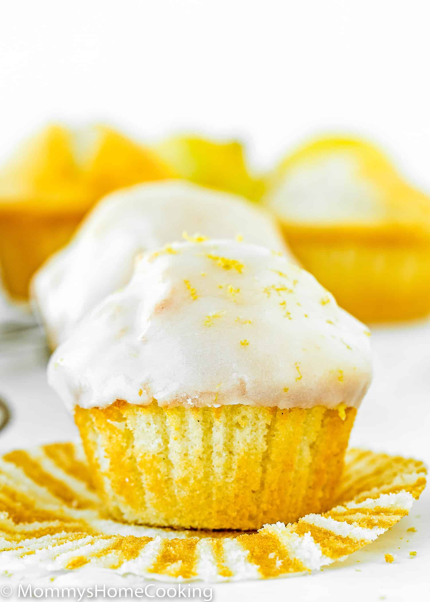 egg-free Lemon Muffin with glaze over a paper liner.