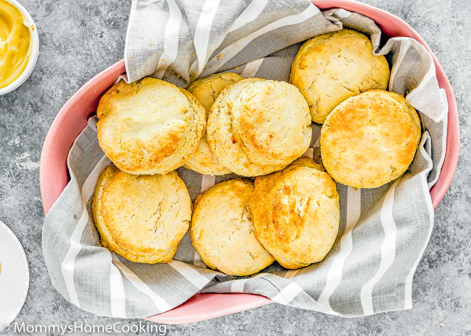 eggless homemade biscuits in a pink serving bowl with a gray kitchen towel.
