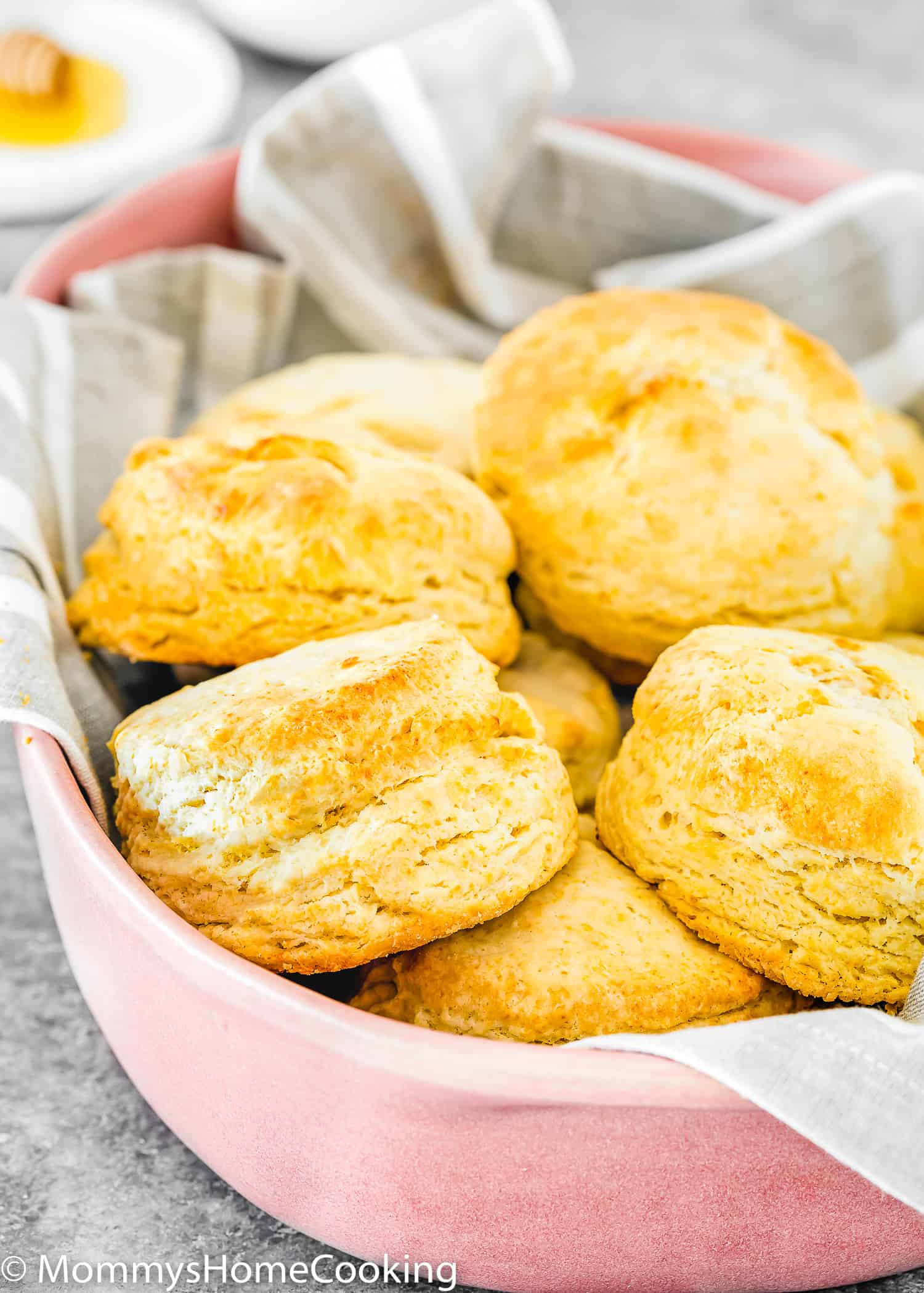 egg-free homemade biscuits in a serving bowl with a gray kitchen towel.
