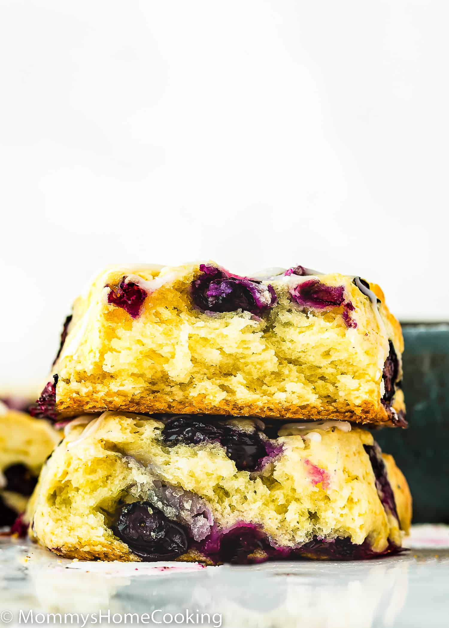 an Eggless Blueberry Scones cut into half showing its inside flaky texture.