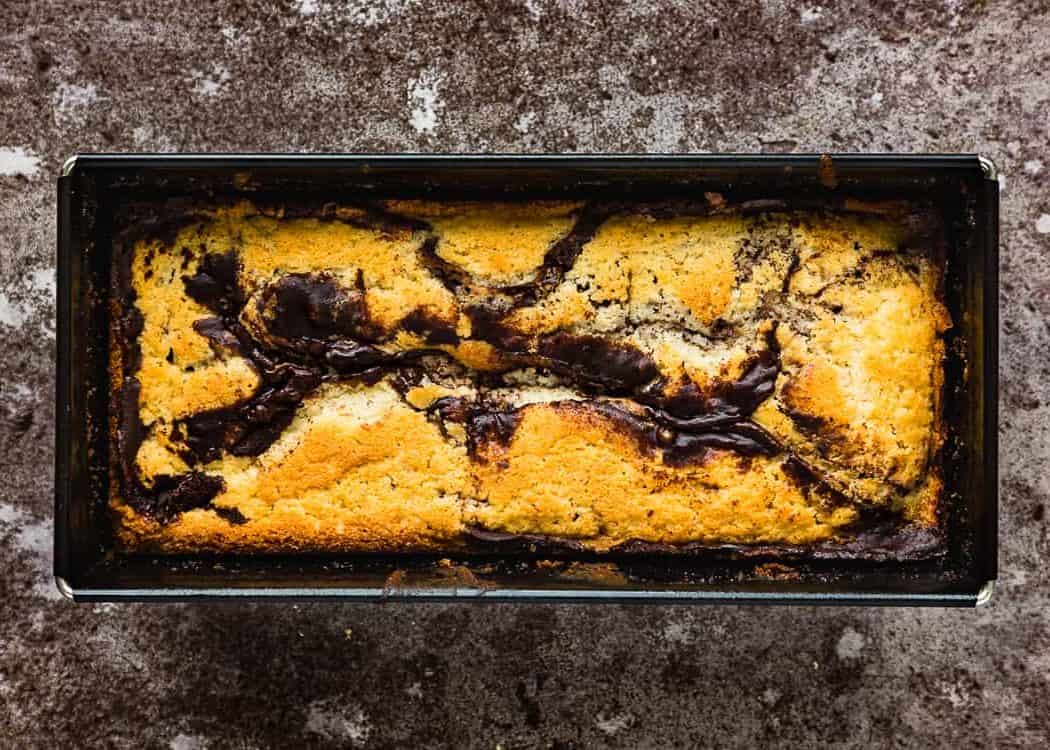 baked egg-free marble cake loaf in a loaf pan. 