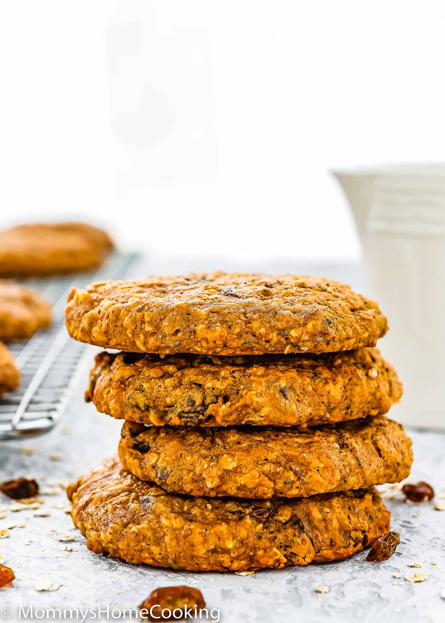 stack of four Dairy-Free & Egg-Free Healthy Breakfast Cookies with a milk jug in the background.