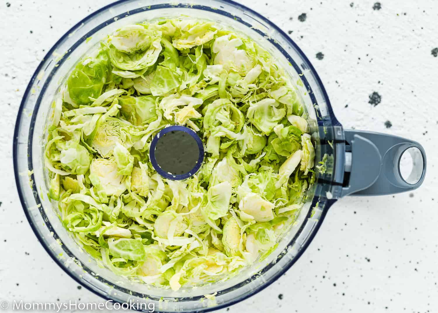 shaved Brussels Sprout in a food processor cup.