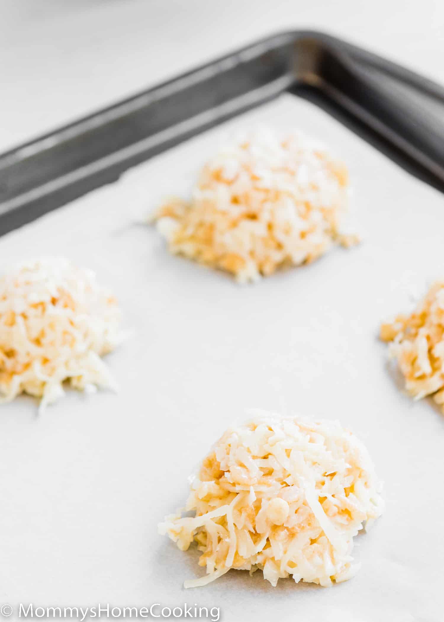 unbaked Eggless Coconut Macaroons over a baking tray.