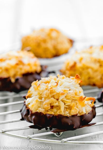 an Eggless Coconut Macaroon dipped in melted chocolate over a rack.