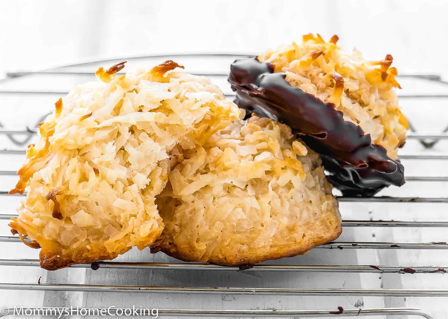 Three Eggless Coconut Macaroons over a cooling rack.