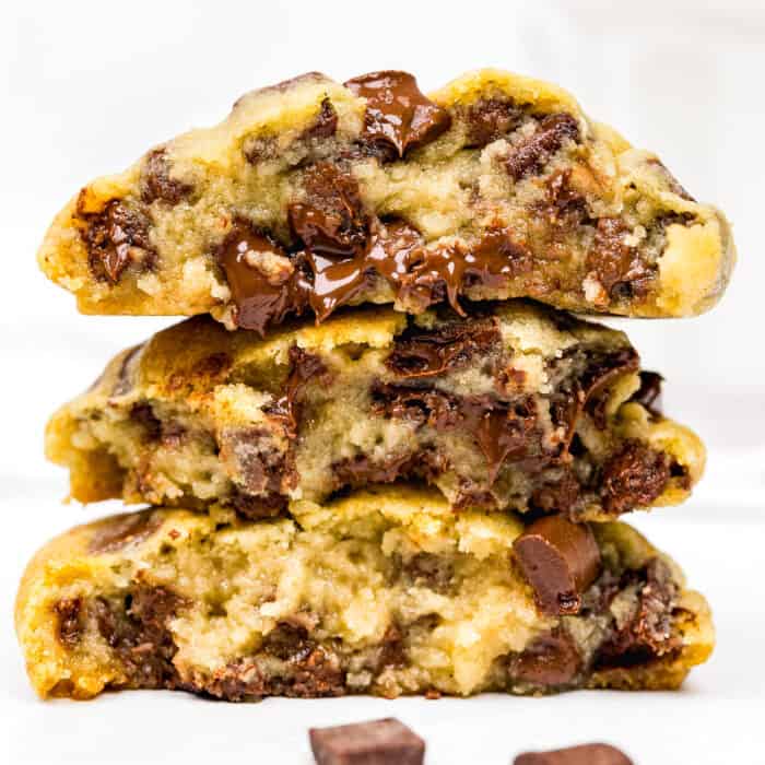 a stack of three egg-free chocolate chip cookies showing their inside texture.