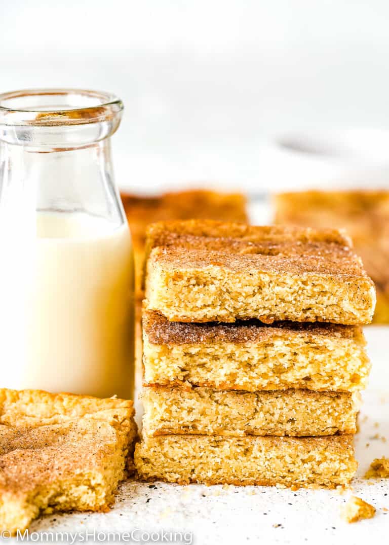 stack of four egg-free Snickerdoodle Bars next to a bottle with milk.