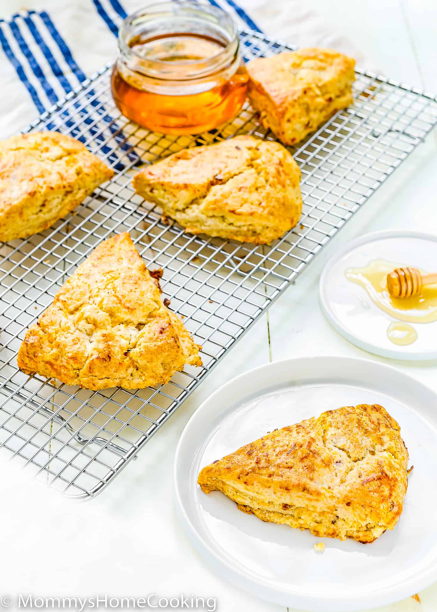 an eggless Bacon Cheddar Scones over a white wooden surface.