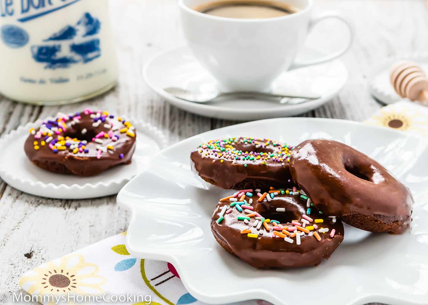 egg-free donuts in a plate with a cup of coffee in the background.
