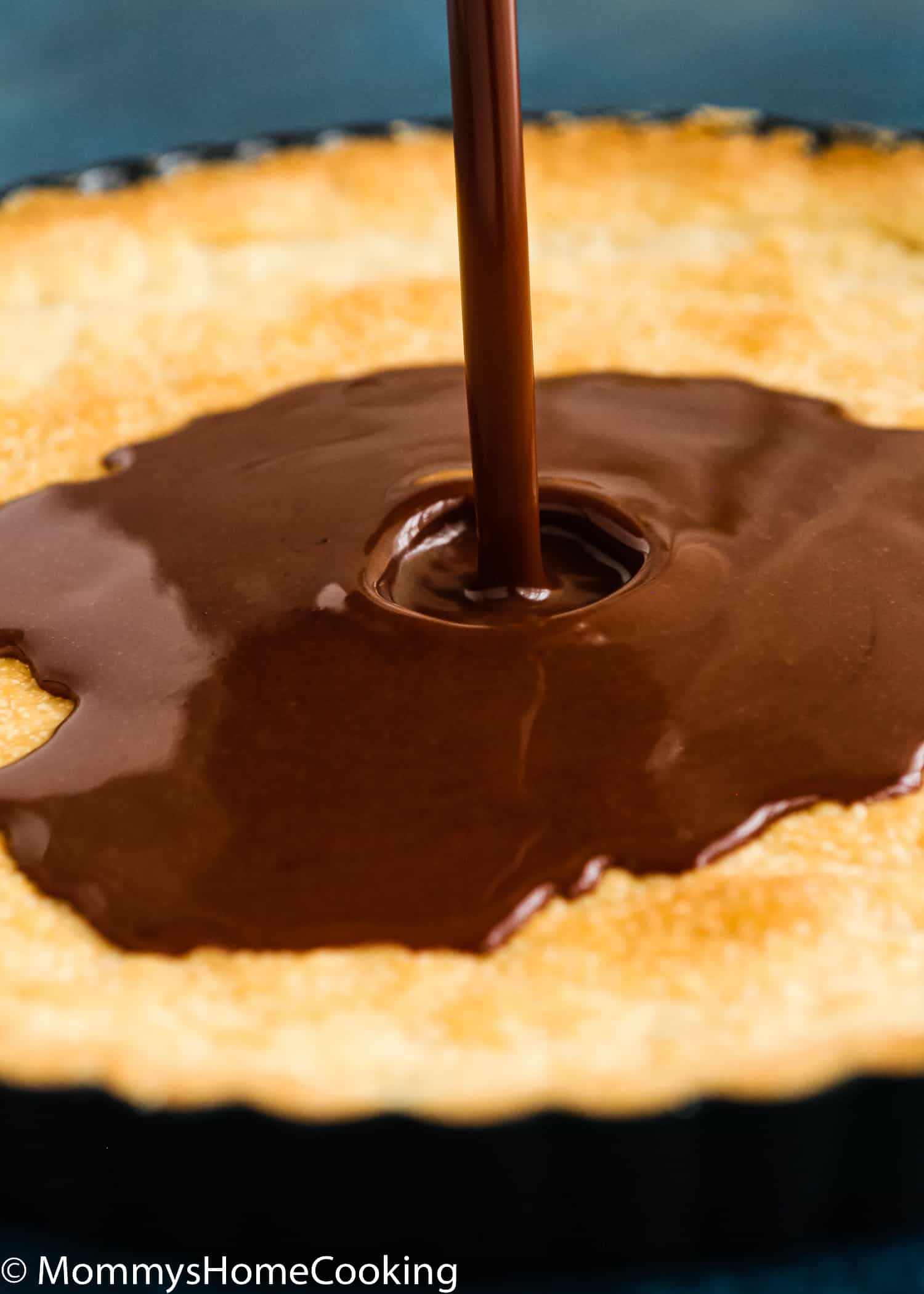 egg-free chocolate filling being poured over a tart crust.