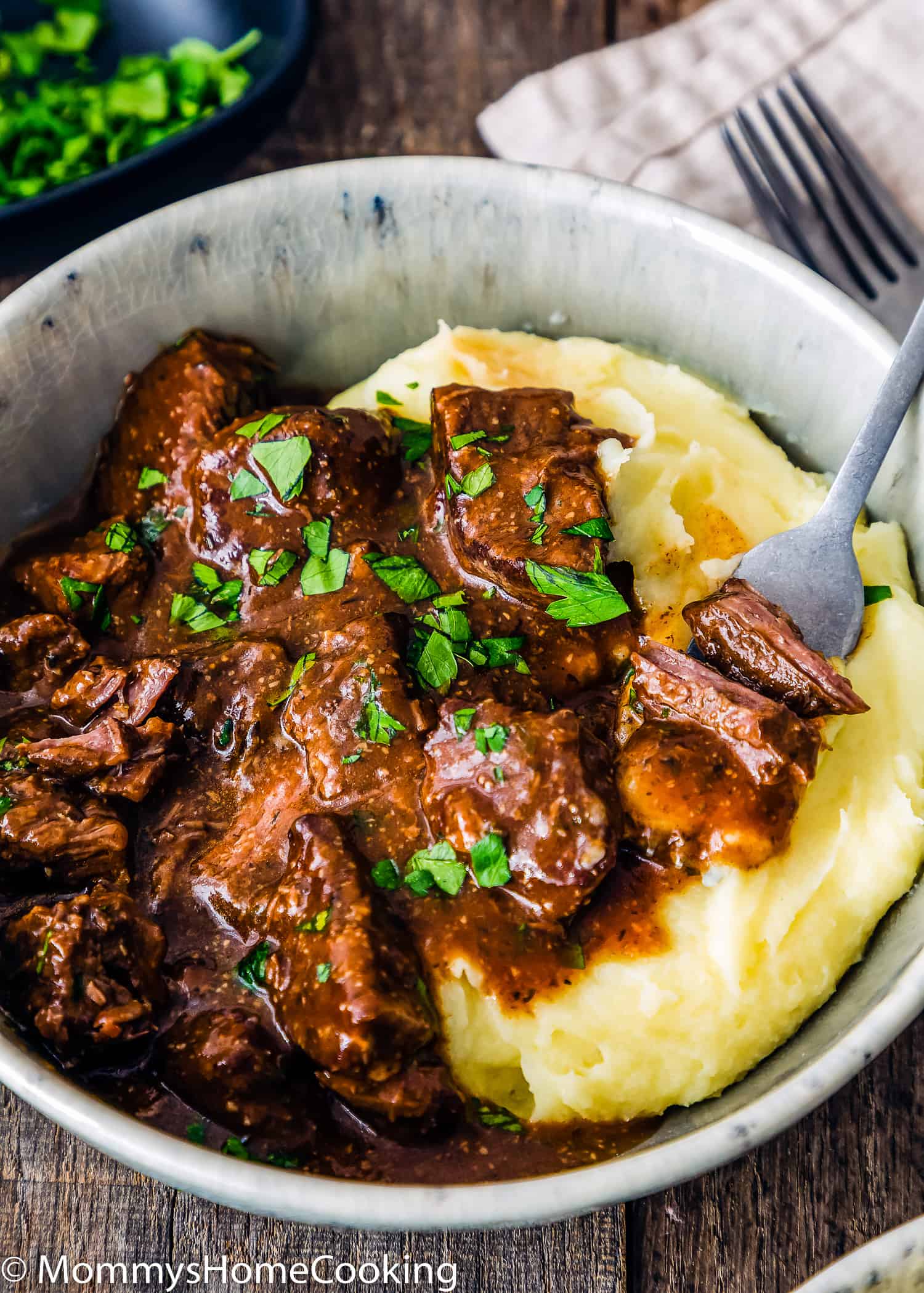 Easy Instant Pot Beef Tips with Gravy in a bowl with mashed potatoes.