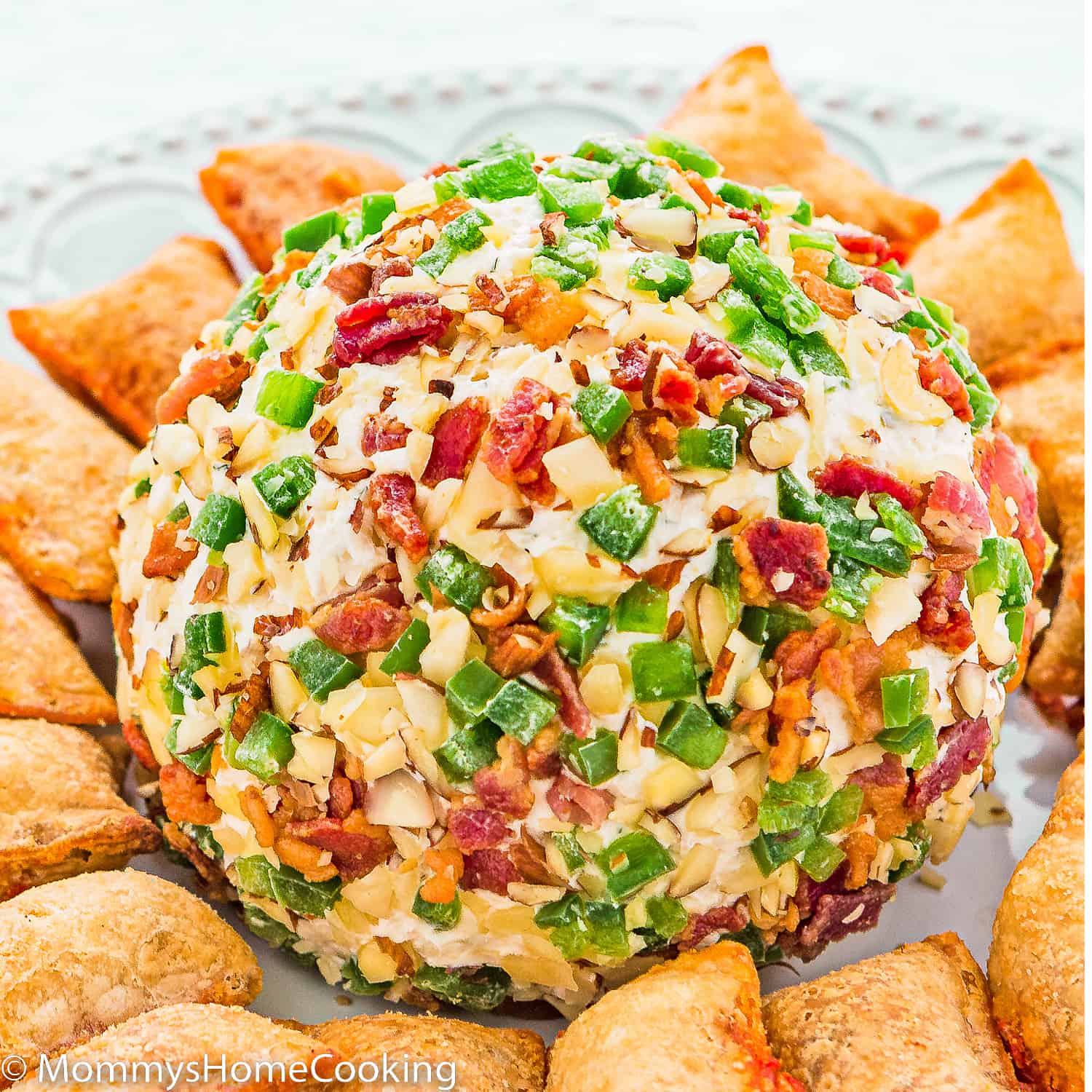 Bacon and Jalapeño Cheese Ball on a plate with pizza bites.