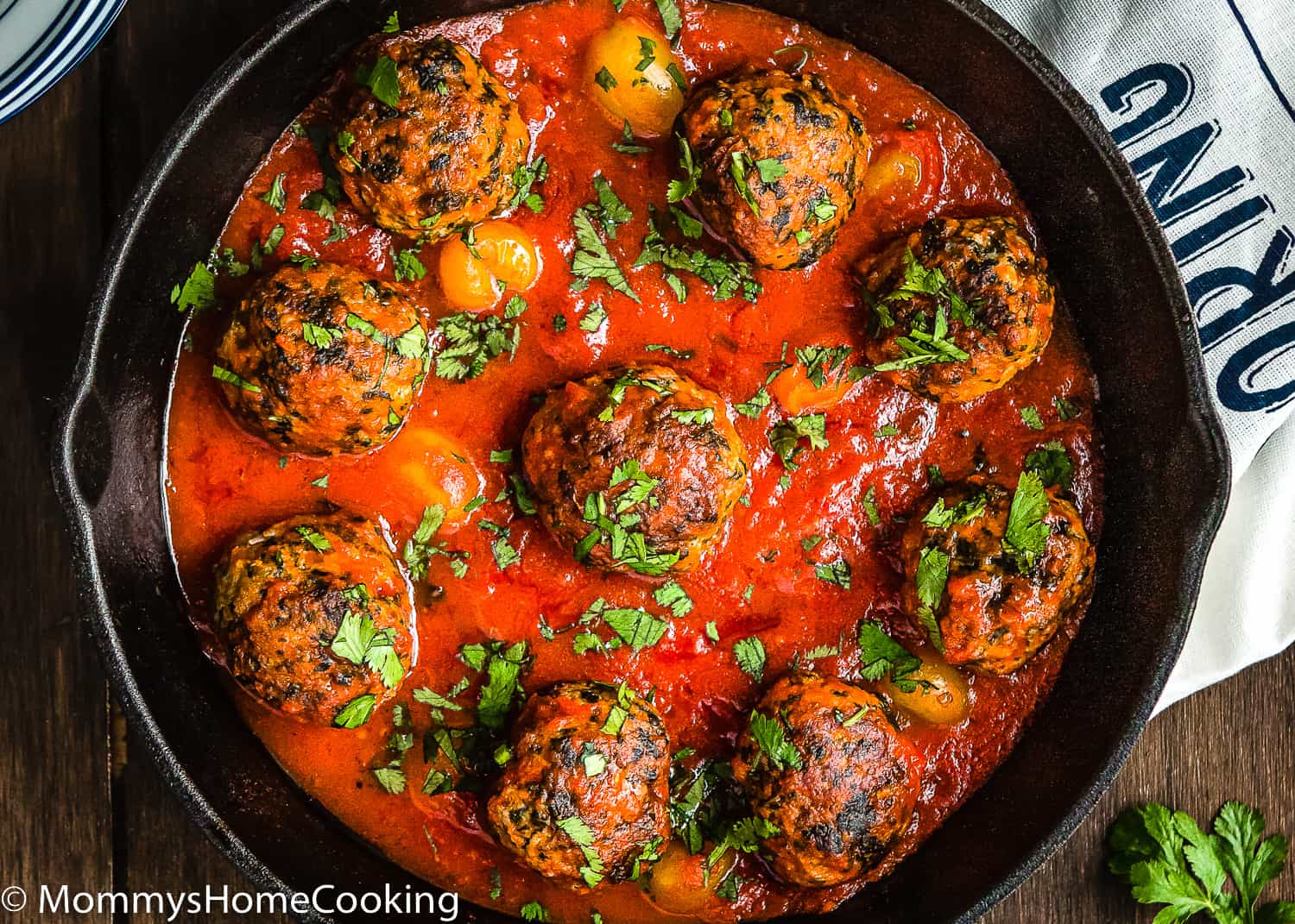 eggless turkey meatballs with marinara sauce in a skillet with chopped basil.