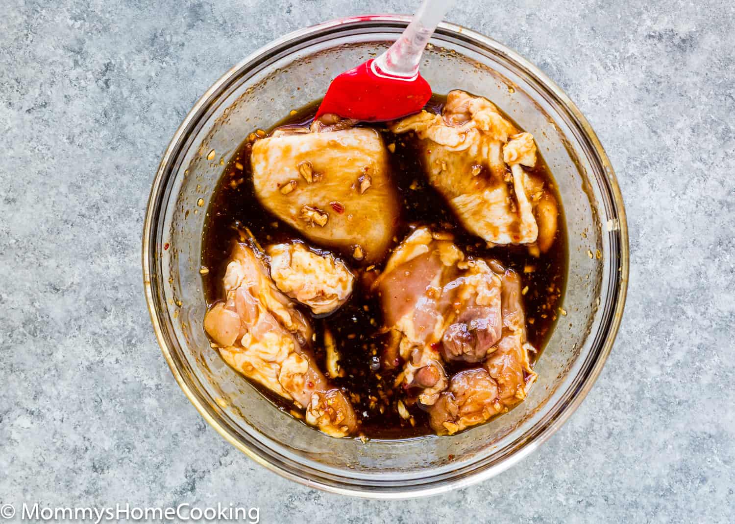 raw chicken in a bowl with thai marinade.