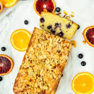 Egg-Free Orange Blueberry Cornbread Loaf over a marble surface.
