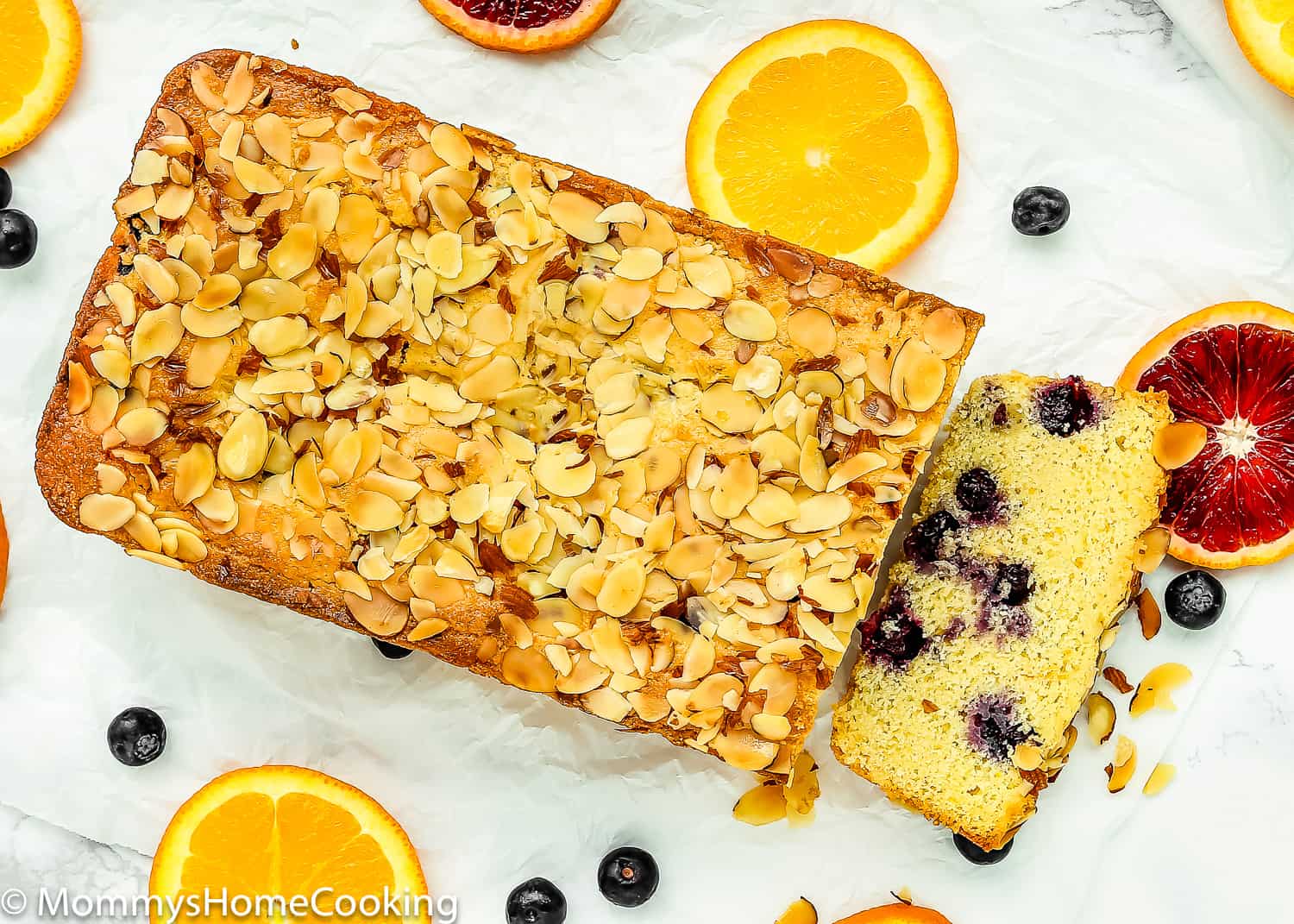 Eggless Blueberry Cornbread Loaf with toasted almonds on top.